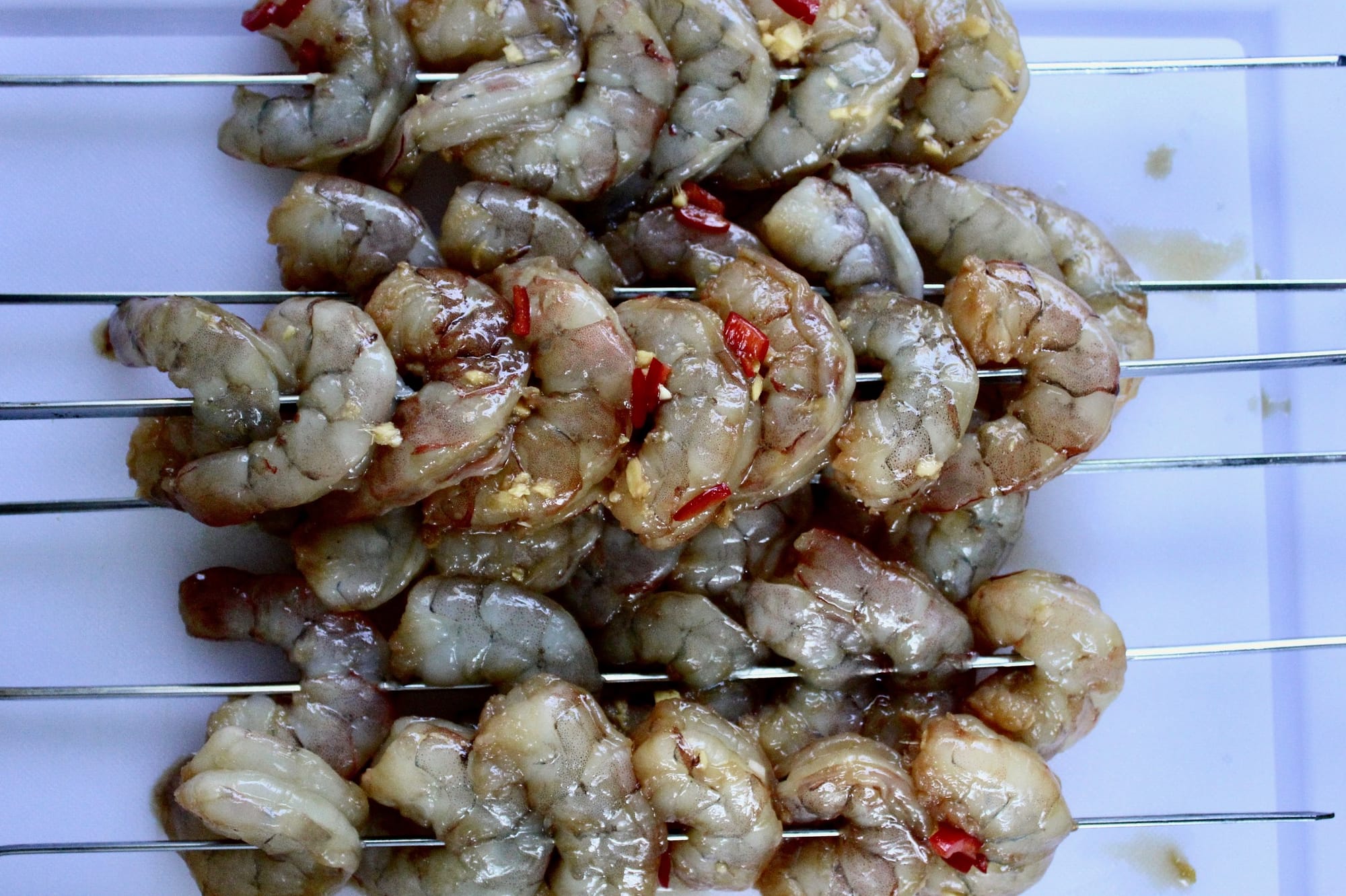 Shrimp skewers ready to be put on the grill. 