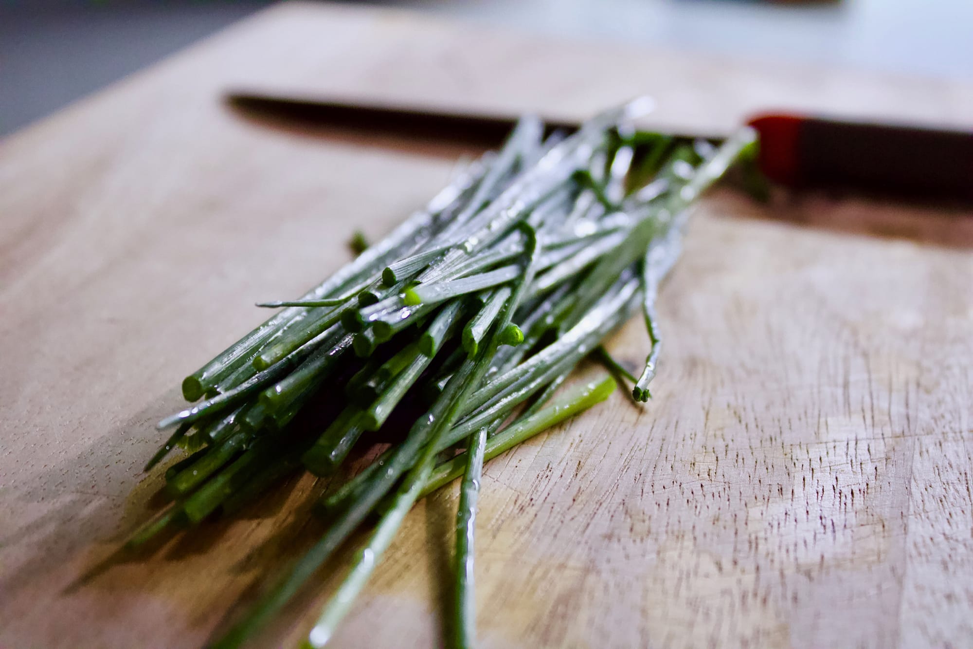 Chives on a cutting board.