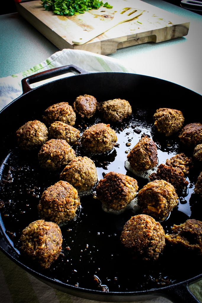 vegan meatballs in a cast iron pan.