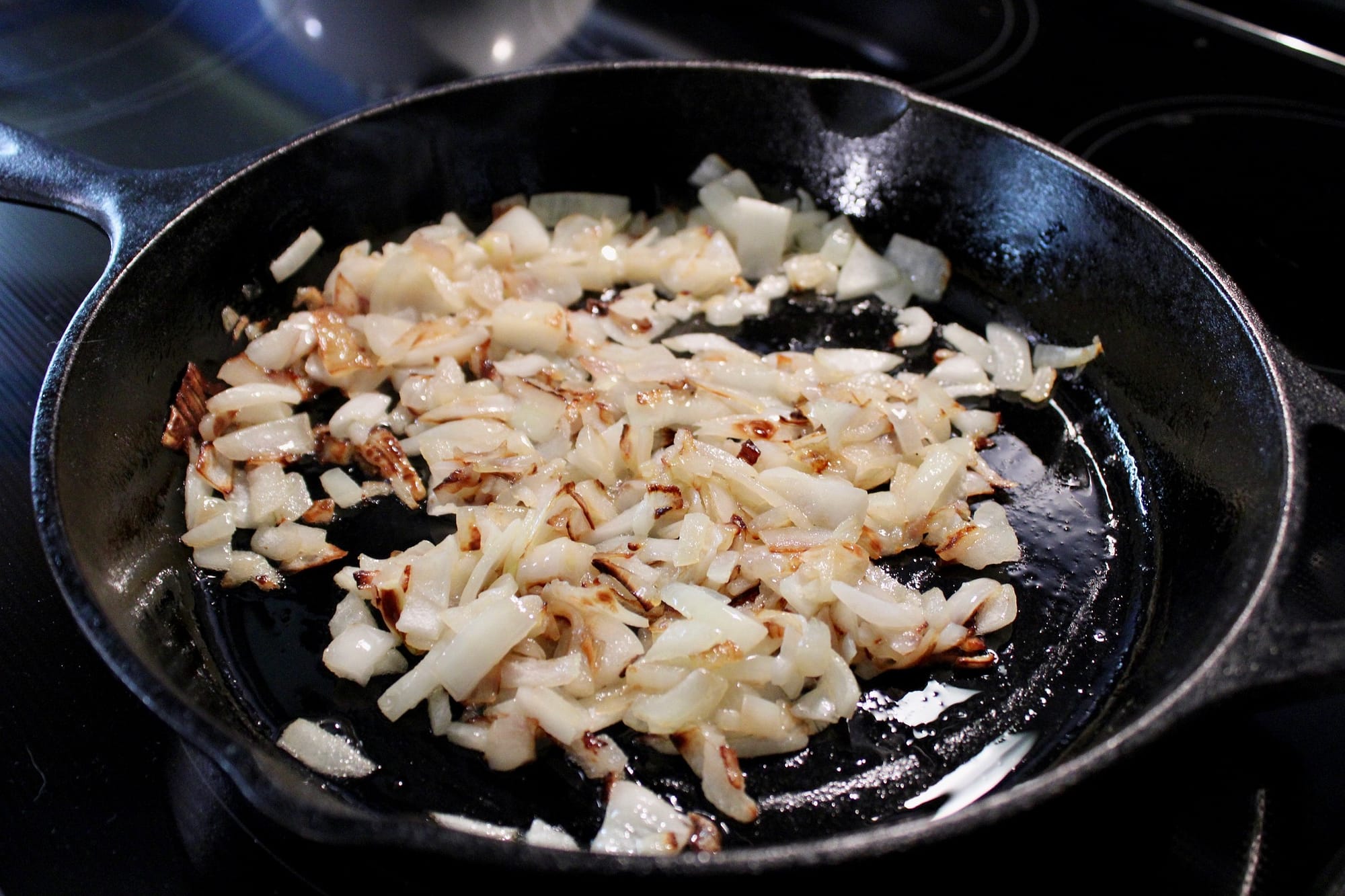 Onions sauteeing in a skillet for the lima beans.