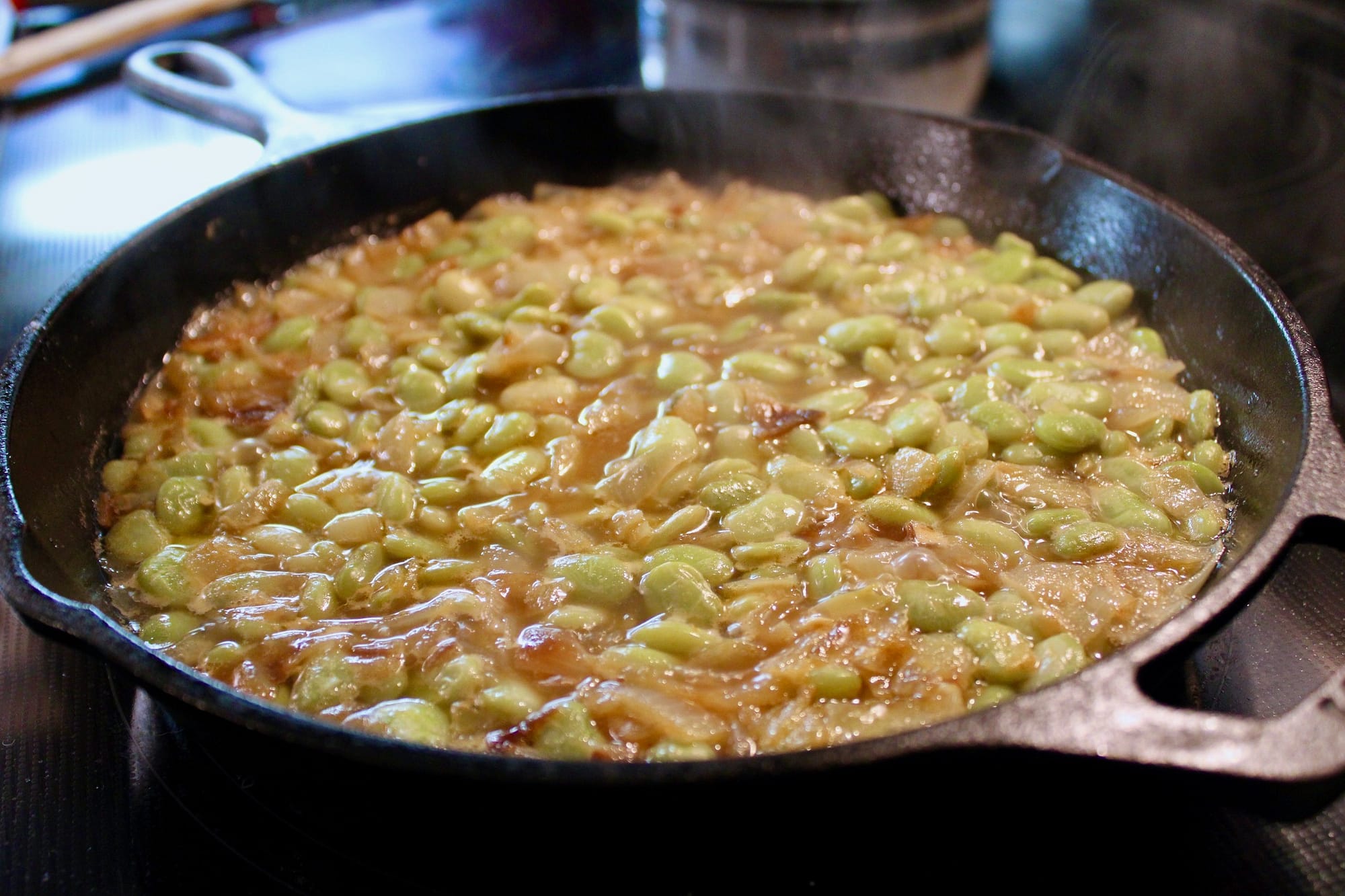 Beans cooking in a skillet.