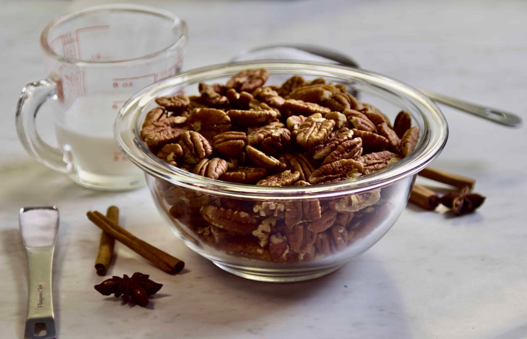 Ingredients for the cinnamon spiced candied nuts laid out on a countertop