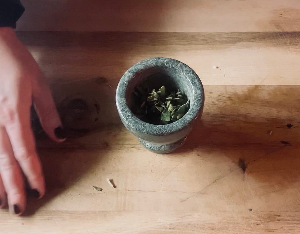 Herbs in a mortar and pestle.