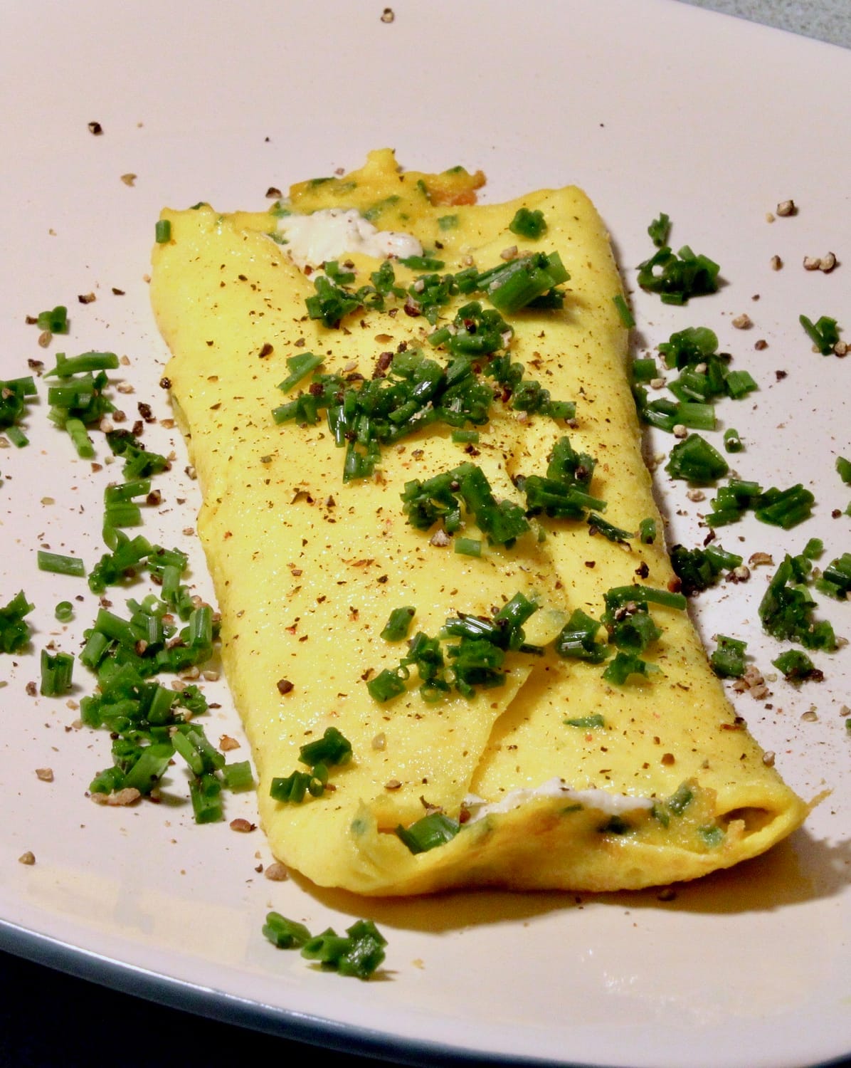 Fully plated and garnished French omelette.