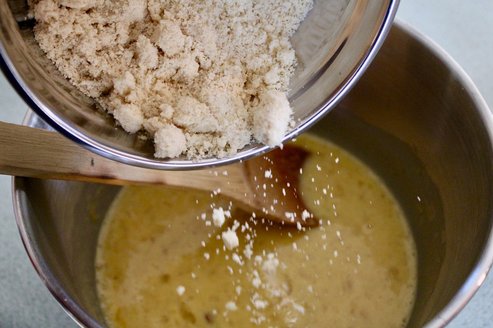 Adding dry ingredients for banana bread.