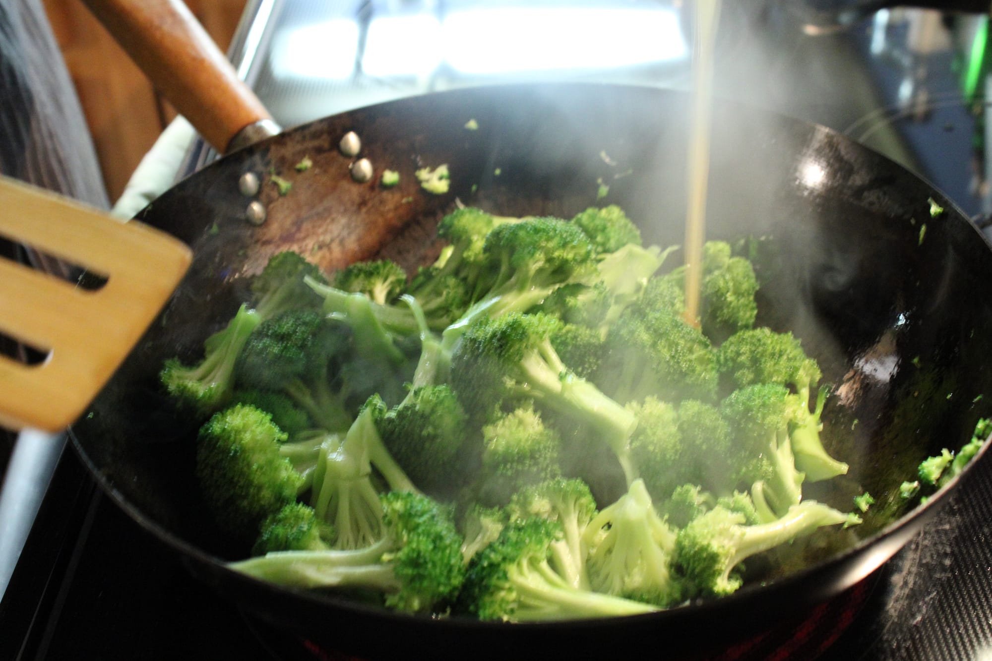 Cooking broccoli in a wok.