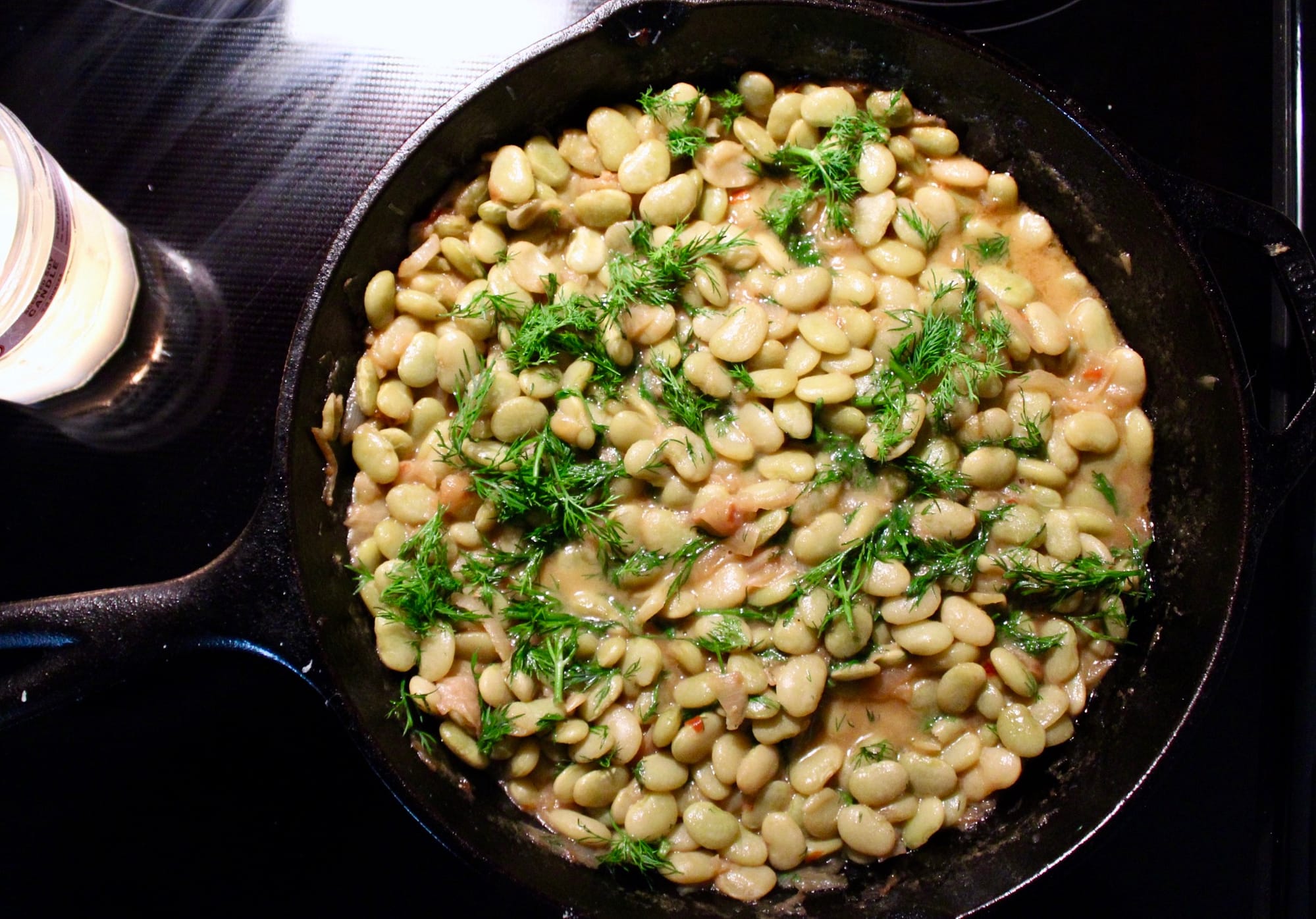 Cast iron skillet filled with Shuggie's Totally Southern Lima Beans.